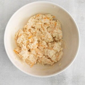 a bowl of mashed carrots in a white bowl.