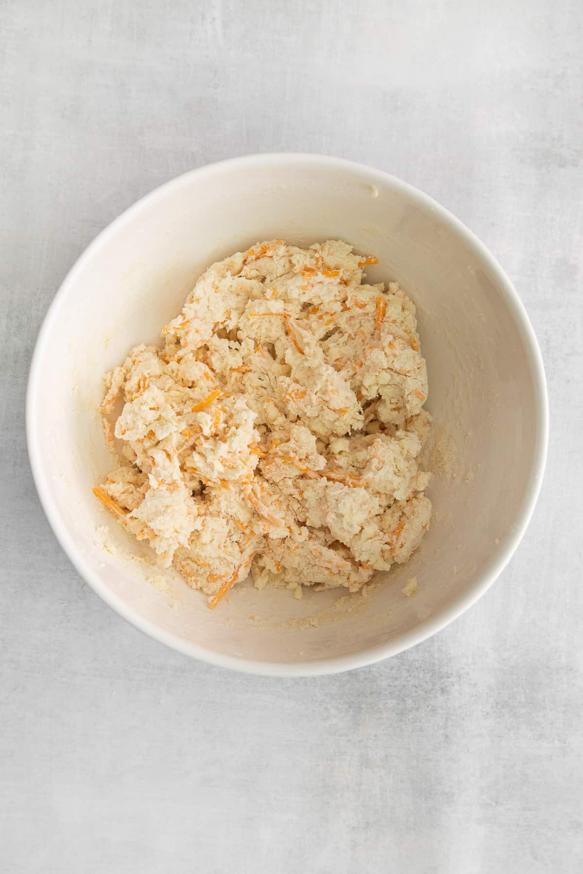 Red lobster cheddar biscuits dough in a bowl.