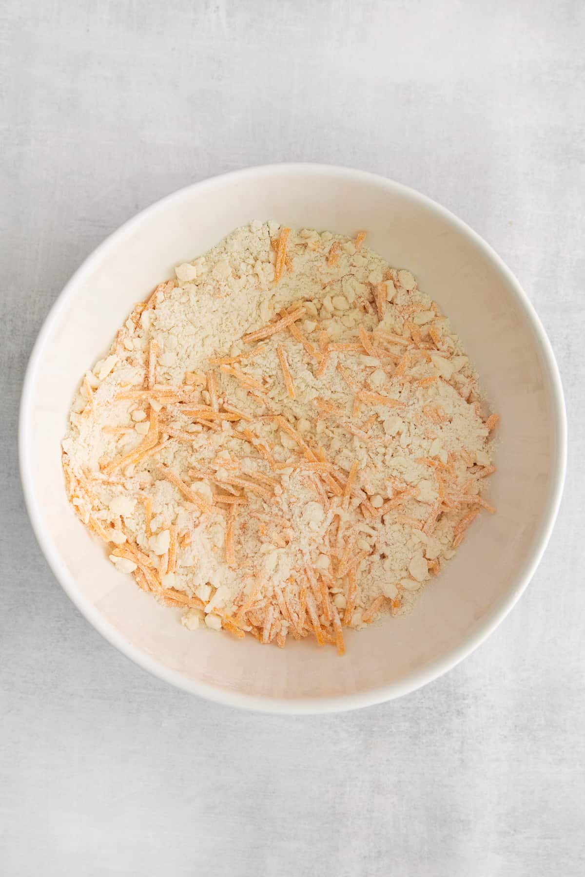 Dry ingredients for cheddar biscuits in a bowl.
