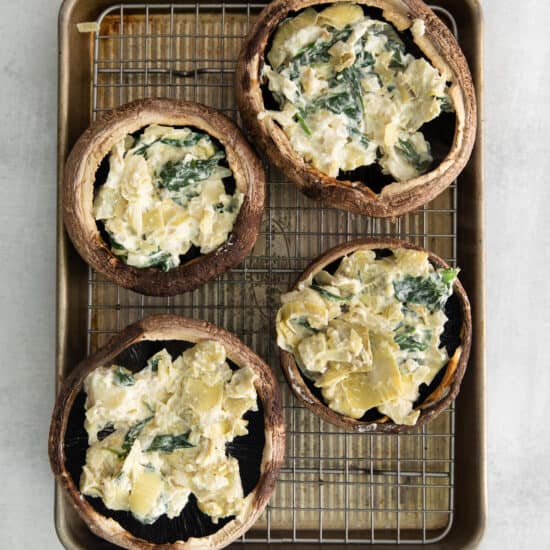 Mushrooms with spinach and artichoke in the middle.