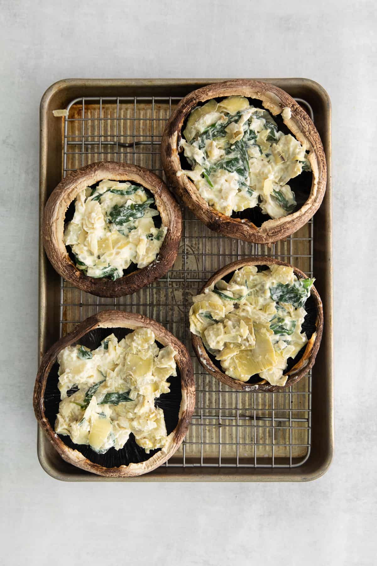 Mushrooms with spinach and artichoke in the middle.