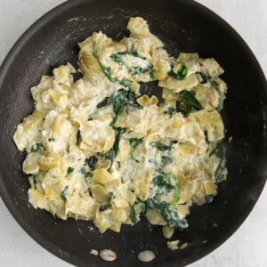 Spinach artichoke dip in a skillet.