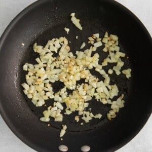 Sauteed onions in a skillet.