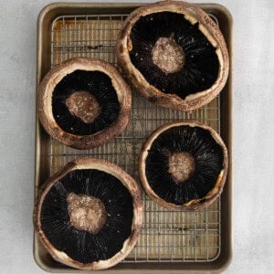 Hallowed out mushrooms on a baking sheet.