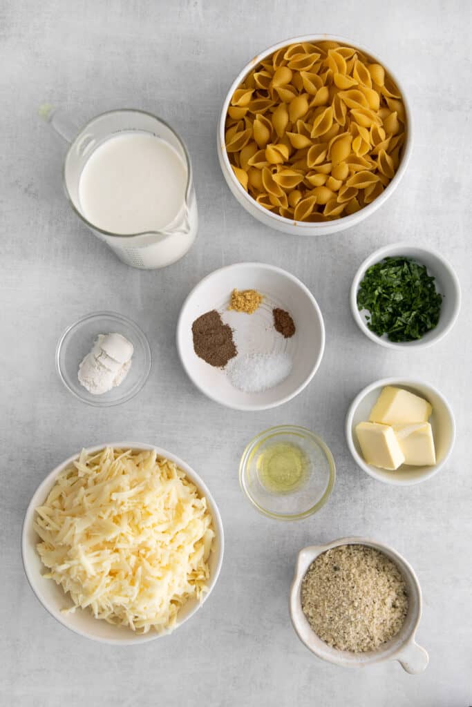 Ingredients for mac and cheese in small bowls. 