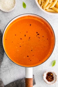 tomato soup in a pan on a white background.