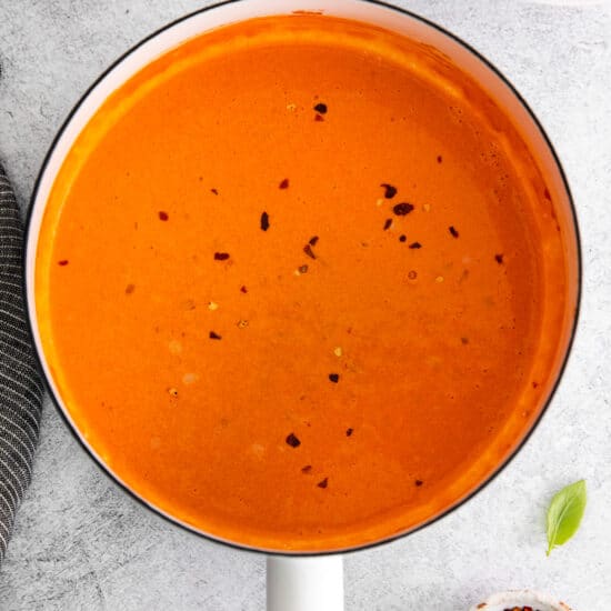 tomato soup in a pan on a white background.