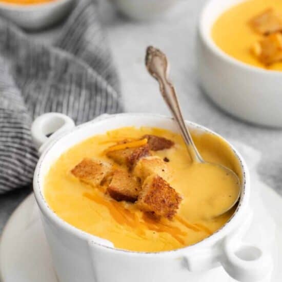 a bowl of Cheddar Cheese Soup with a spoon