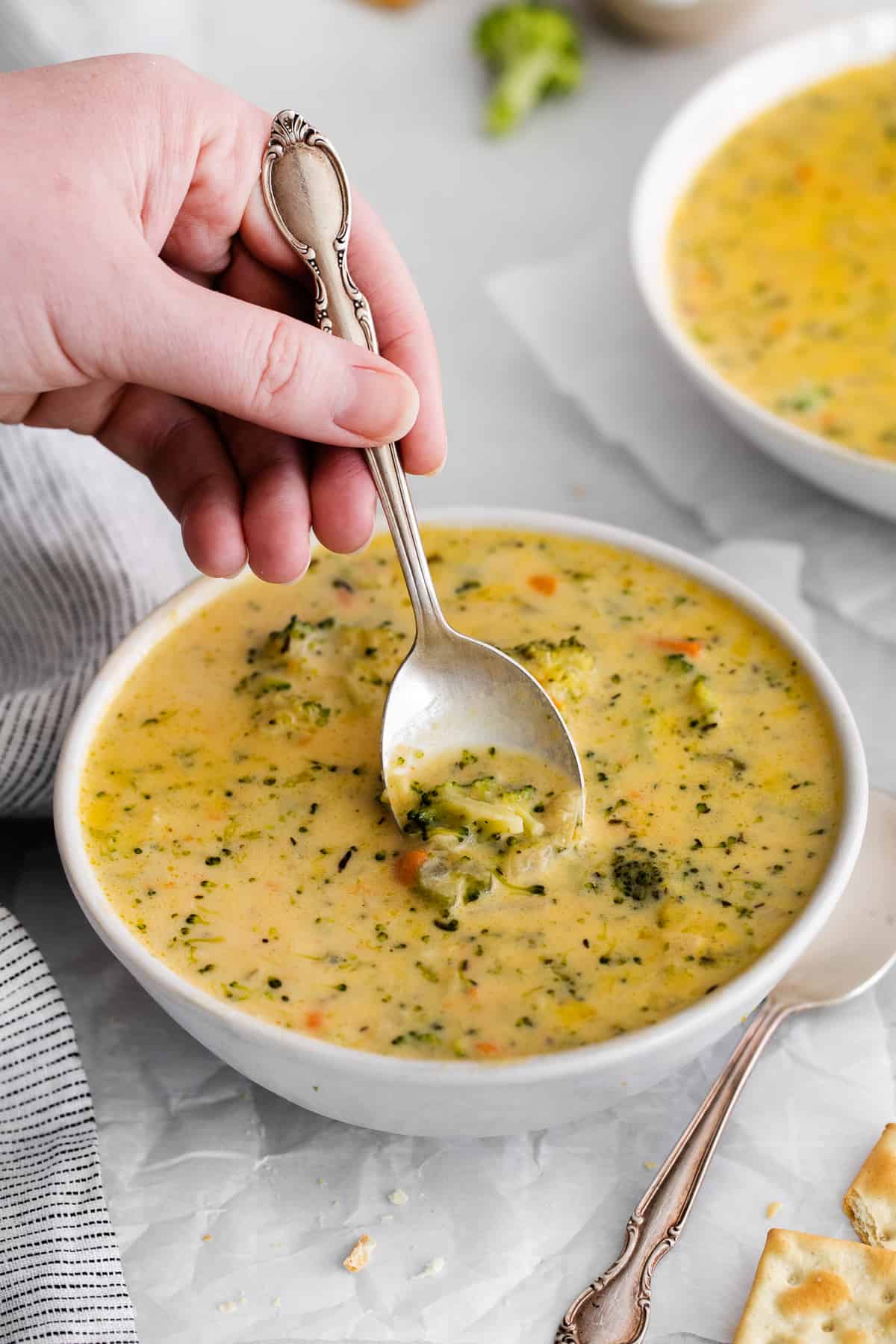 A spoon scooping a spoonful of soup.