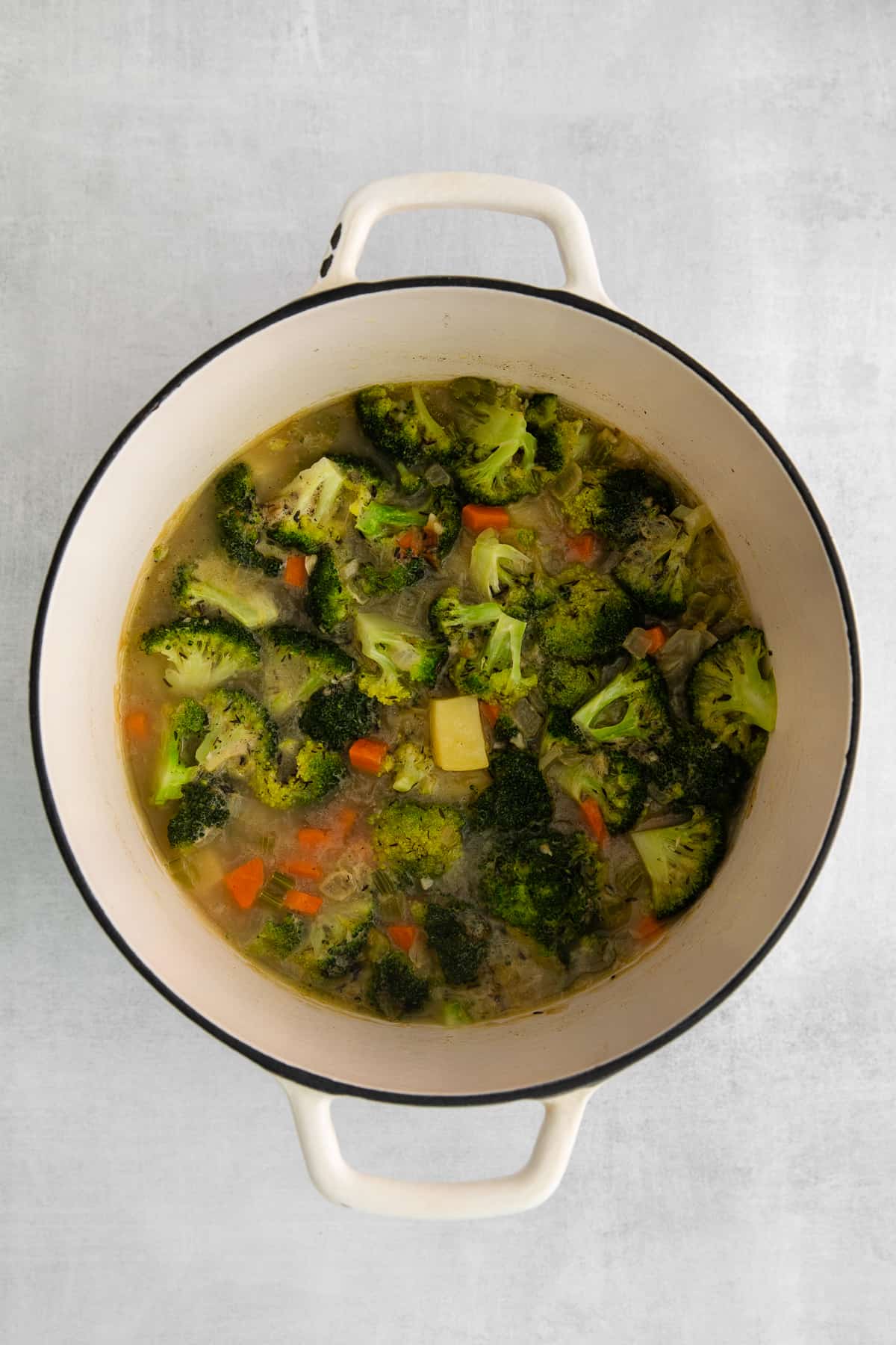 Simmering all the vegetables together in a pot.