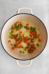 Sauteeing vegetables in a pot.