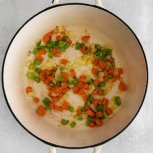 Sauteeing vegetables in a pot.