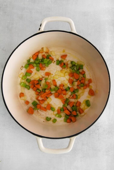 Sauteeing vegetables in a pot.
