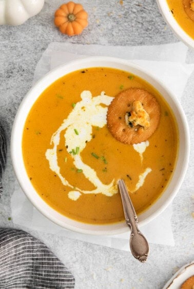 pumpkin soup in bowl with ritz cracker.