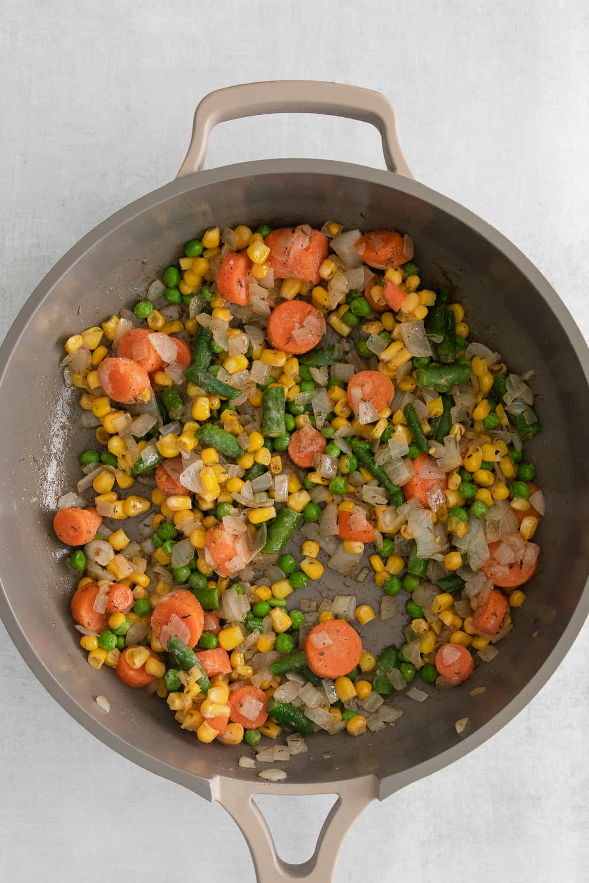 cooking veggies in pan.