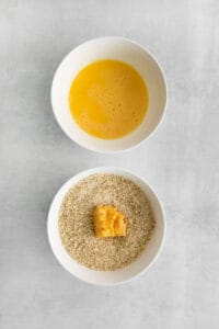 a bowl of rice and a bowl of orange juice.