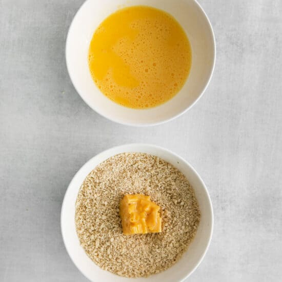 a bowl of rice and a bowl of orange juice.