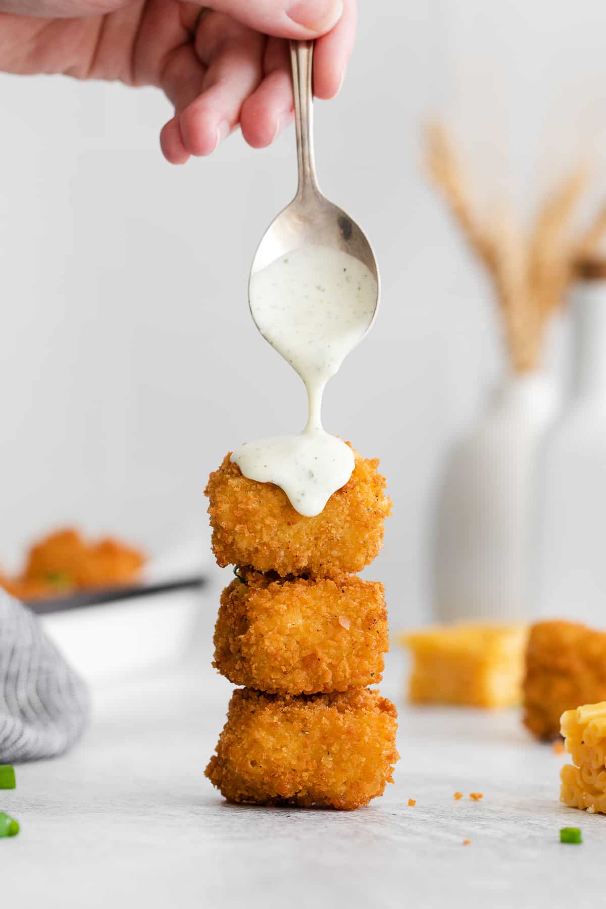 drizzling fried mac and cheese with ranch.