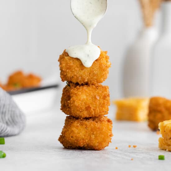 drizzling fried mac and cheese balls with ranch.