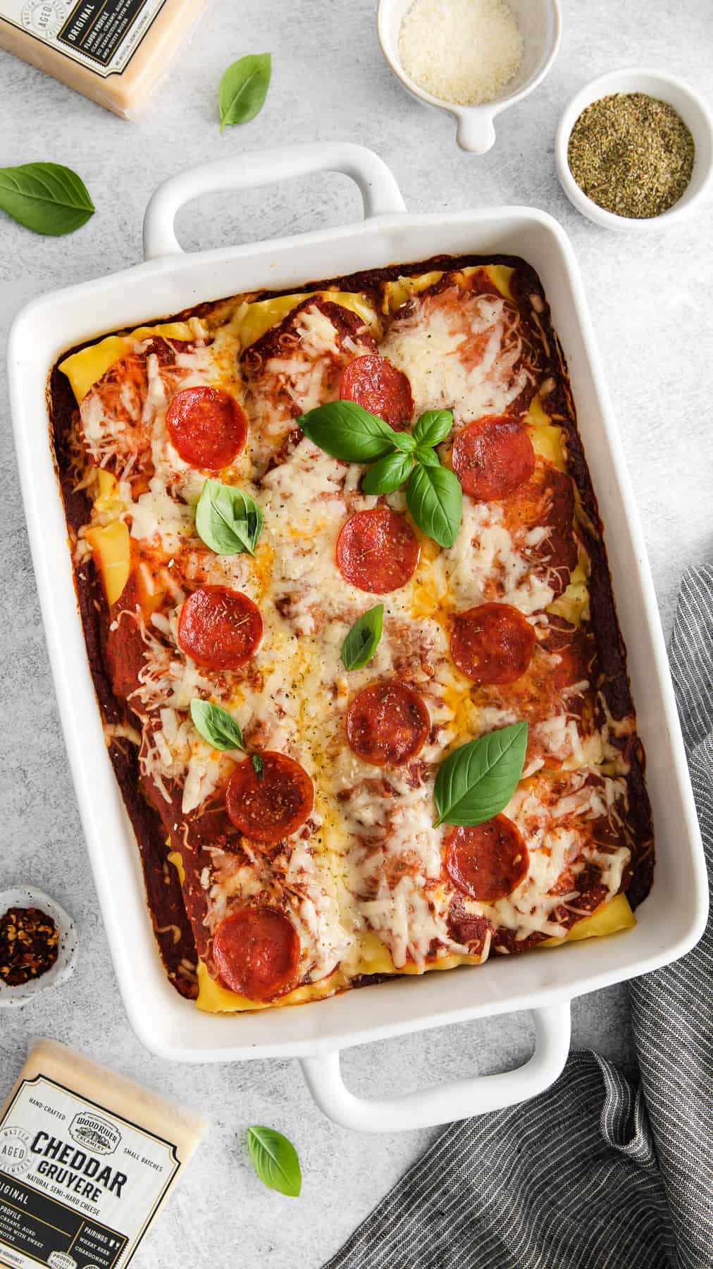 Pizza lasagna roll ups in a casserole dish.