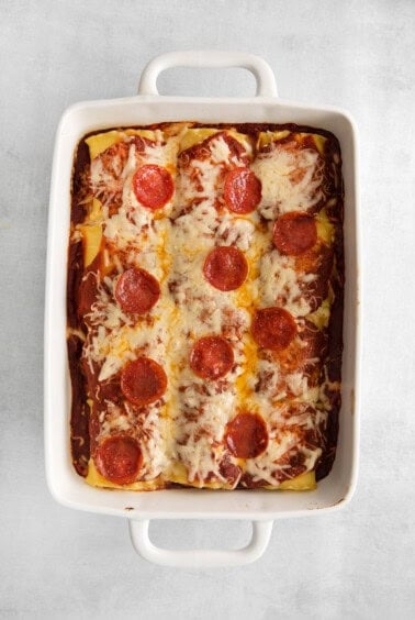 pizza lasagna roll ups in casserole dish.