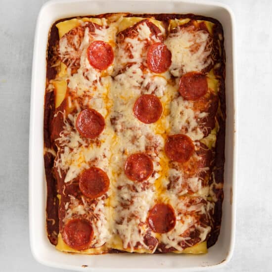 pizza lasagna roll ups in casserole dish.