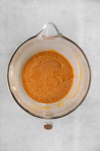 a glass bowl filled with a red sauce.