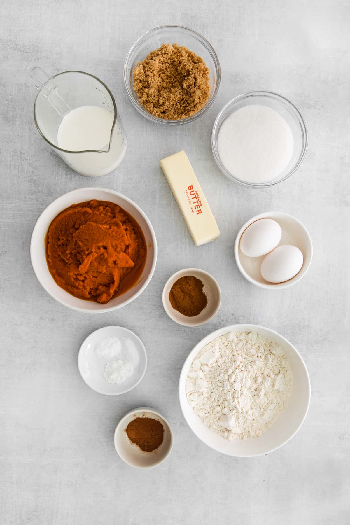 Ingredients for pumpkin bars with cream cheese frosting in bowls.