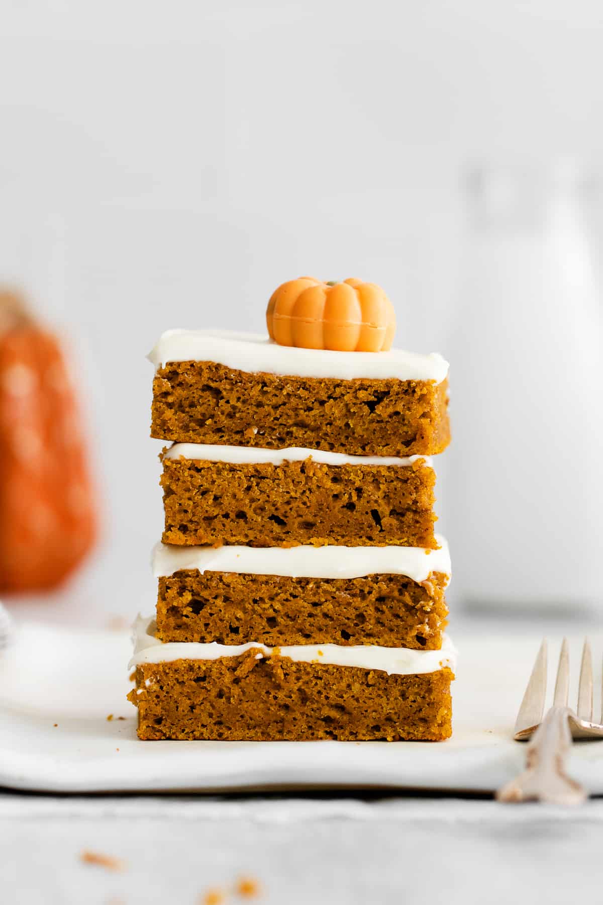 Pumpkin bars stacked 4 high on a plate.