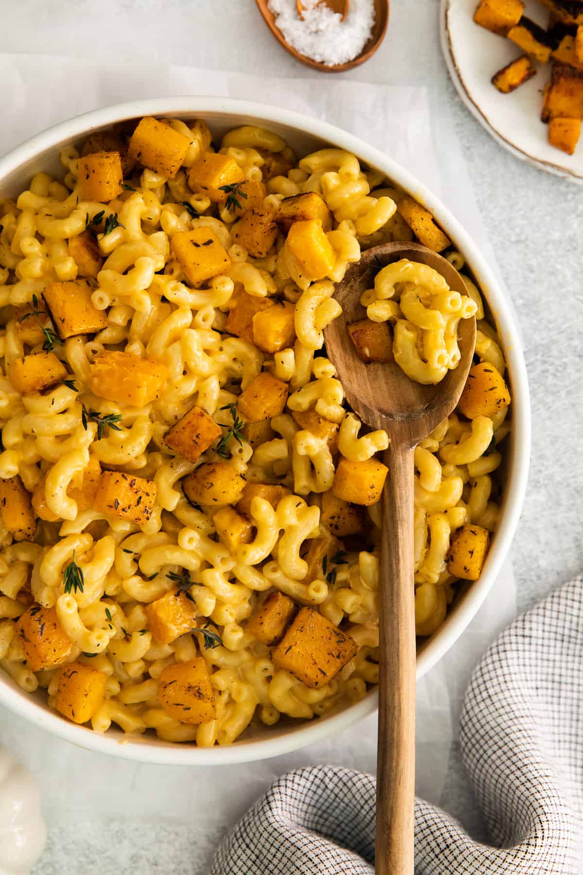 pumpkin mac and cheese in bowl with spoon.