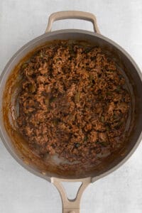 a skillet full of ground beef in a pan.