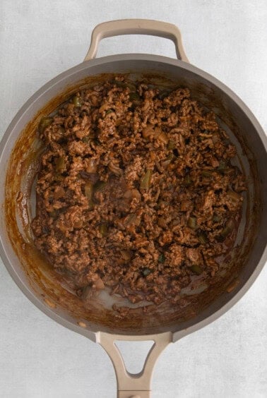 a skillet full of ground beef in a pan.