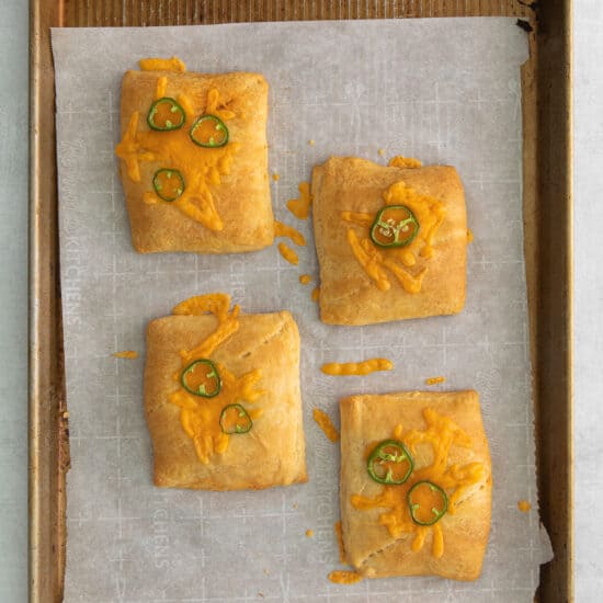cheesy jalapeno poppers on a baking sheet.