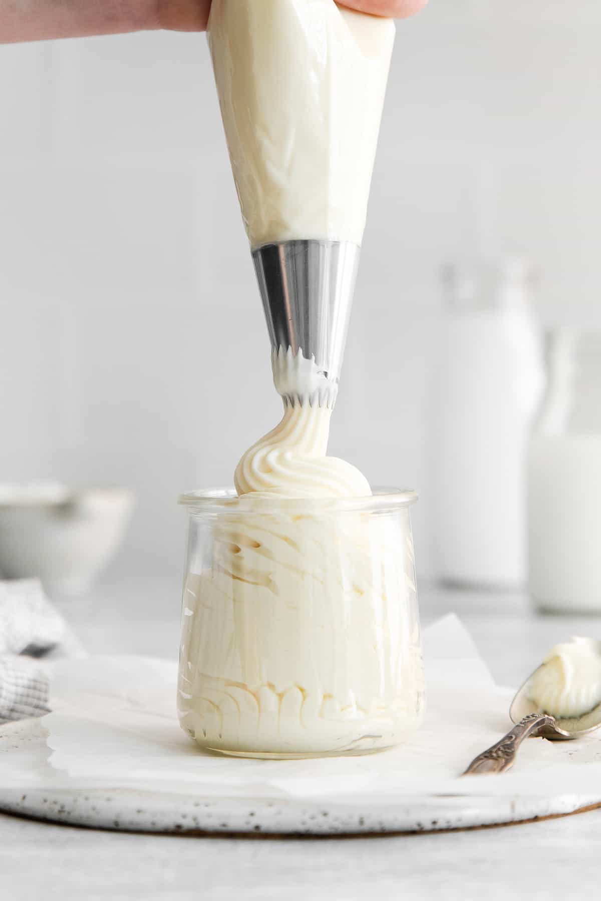 Piping frosting into a jar. 