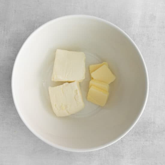 Cream cheese and butter in a bowl.