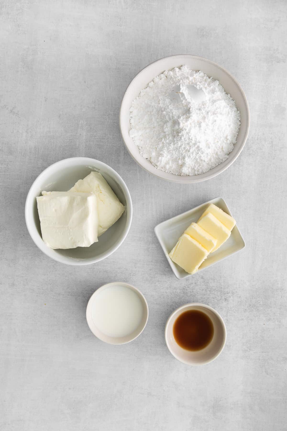 The ingredients for frosting in small bowls. 