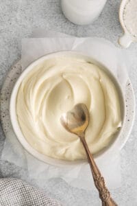 Thick whipped cream cheese frosting in bowl.