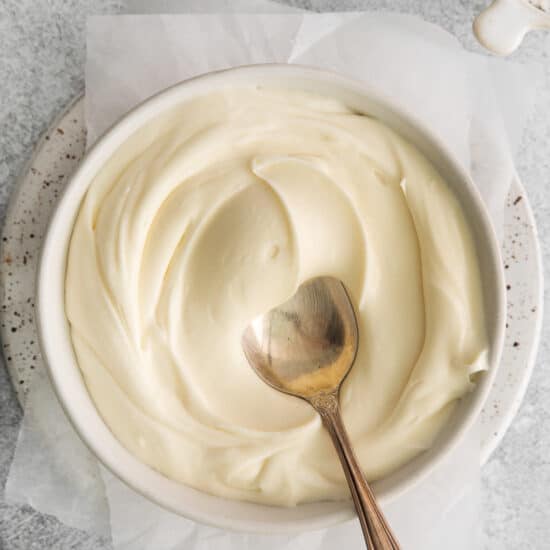 Thick whipped cream cheese frosting in bowl.