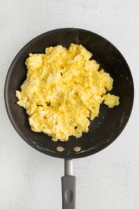 scrambled eggs in a frying pan.