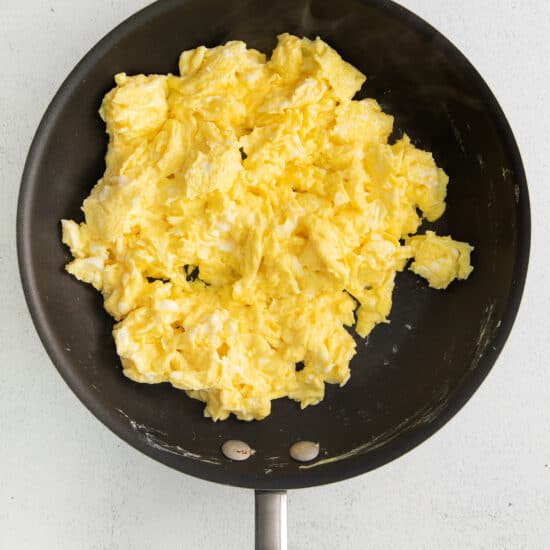 scrambled eggs in a frying pan.