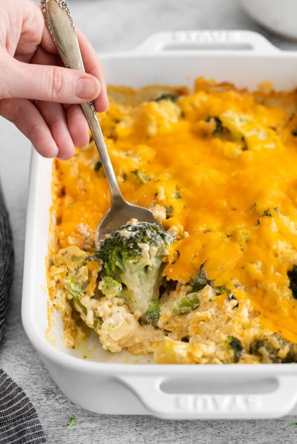 Broccoli cheese casserole on a spoon.