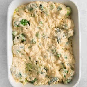 a casserole dish filled with broccoli and cheese.