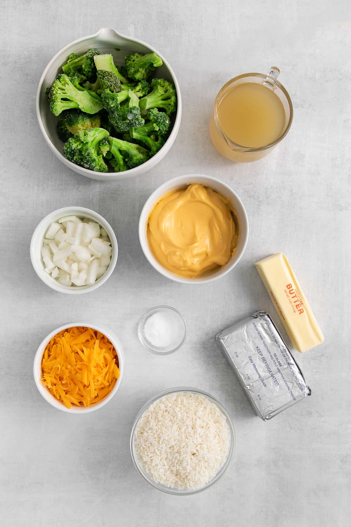 Ingredients for broccoli cheese casserole in bowls.
