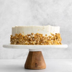 a white cake on a wooden stand.