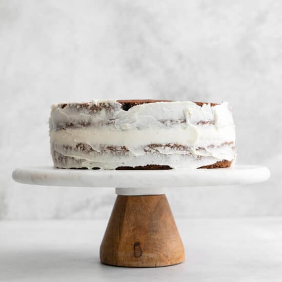 a cake sitting on a wooden stand.