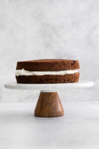 a chocolate cake on a wooden stand.