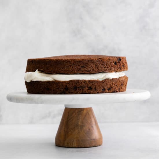 a chocolate cake on a wooden stand.