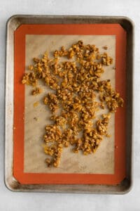 toasted walnuts on a baking sheet.