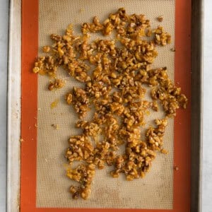 toasted walnuts on a baking sheet.