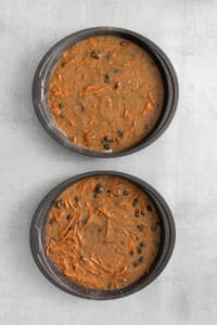 two baking pans filled with carrot cake batter.